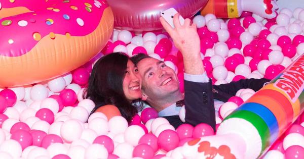 couple having fun in candy ball pit